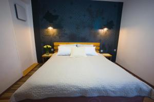 a bedroom with a large bed with two pillows at FRIZ&FANY Charm House in Postojna