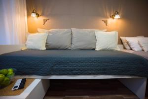 a bed with white pillows and a green blanket at FRIZ&FANY Charm House in Postojna +33 photos