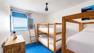 a bedroom with two bunk beds and a window at Coast anza house in Agadir