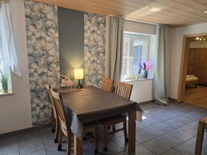 a dining room with a table and some chairs at Haus Blume in Medebach