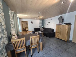 a living room with a table and a couch at Haus Blume in Medebach +42 photos