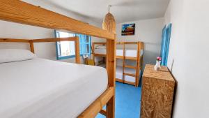 a bedroom with a bed and a bunk bed and a ladder at Coast anza house in Agadir