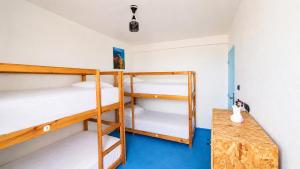 a room with two bunk beds and a table at Coast anza house in Agadir +4 photos