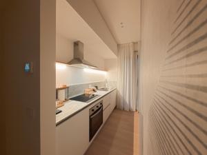 a kitchen with white counters and a stove at Loft 26 Apartment in Caltanissetta