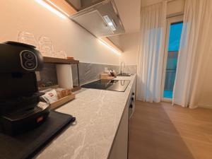 a kitchen with a sink and a counter top at Loft 26 Apartment in Caltanissetta
