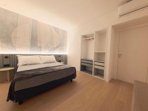 a bedroom with a bed and a large painting on the wall at Loft 26 Apartment in Caltanissetta +7 photos