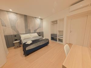 a bedroom with a bed and a table in a room at Loft 26 Apartment in Caltanissetta