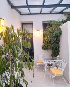 a patio with a table and chairs and plants at ZOE in Keramoto