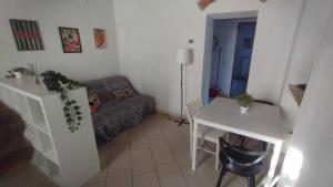 a living room with a couch and a table at Dimora toscana in Santa Maria del Giudice