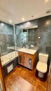 a bathroom with a toilet and a sink and a tub at Exception Ski Émerveillement in Pas de la Casa +27 photos