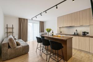 a kitchen and living room with a couch and a table at Willa Horyzont in Hel