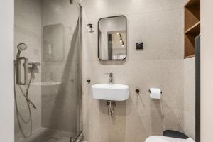 a bathroom with a sink and a shower at Willa Horyzont in Hel +26 photos