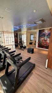 a gym with a bunch of exercise equipment in a room at Premium Suite - Perdizes - Luxury & Panoramic View in São Paulo