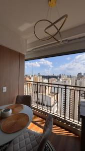 a balcony with a table and a view of a city at Premium Suite - Perdizes - Luxury & Panoramic View in São Paulo