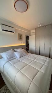 a bedroom with a large white bed with a ceiling at Premium Suite - Perdizes - Luxury & Panoramic View in São Paulo +16 photos