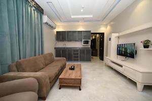a living room with a couch and a coffee table at فندق ان فيولا in Jazan