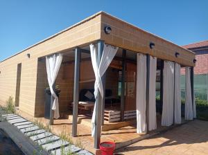 a brick house with white curtains on it at solar eclipse house in Husillos
