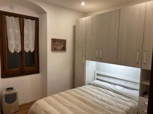 a bedroom with a bed and wooden cabinets at Seroa 1 in San Bernardino