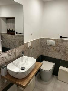 a bathroom with a sink and a toilet at Seroa 1 in San Bernardino +18 photos