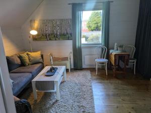 a living room with a couch and a table at Smia in Søgne