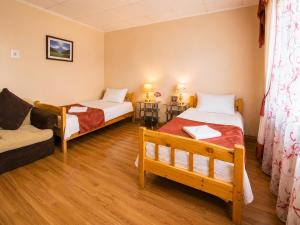 a room with two beds and a couch at LG53 Tour & Hostel in Ulaanbaatar