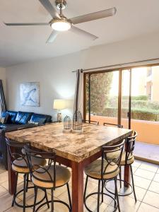 a kitchen with a large wooden table and chairs at Sandy Beach Princesa D101 Ocean Front Resort in Puerto Peñasco