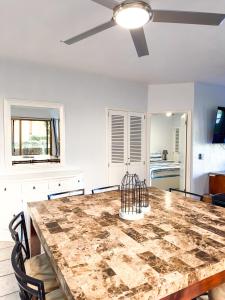 a dining room with a table and a ceiling fan at Sandy Beach Princesa D101 Ocean Front Resort in Puerto Peñasco +56 photos