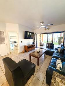 a living room with a couch and a table at Sandy Beach Princesa D101 Ocean Front Resort in Puerto Peñasco