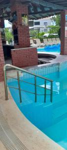 a swimming pool with a hand rail in the water at Rayon Apart hotel in Marmaris
