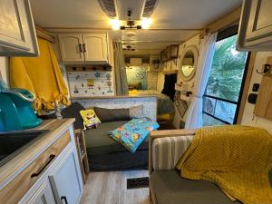 an rv with a couch and a table in it at SpongeBob SquarePants on the River in Bullhead City