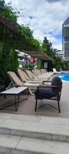 a row of lounge chairs sitting next to a pool at Rayon Apart hotel in Marmaris +13 photos