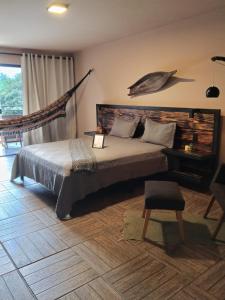 a bedroom with a large bed with a wooden headboard at Hotel Sinhá in Tianguá +52 photos