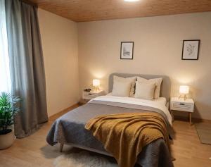 a bedroom with a large bed with two night stands at Alp House in Bohinjska Bela
