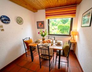 a dining room with a table and chairs and a window at Alp House in Bohinjska Bela +27 photos
