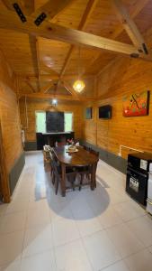 a dining room with a wooden table and chairs at Cabaña Arashi in Tafí del Valle