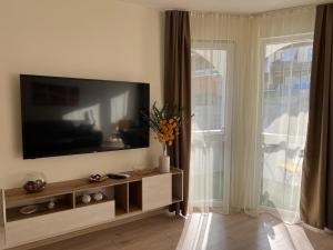 a living room with a flat screen tv on a wall at Barceló Apartment Velingrad in Velingrad
