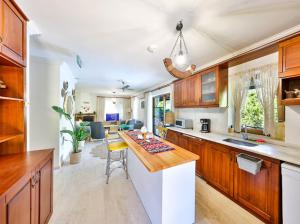 a kitchen with wooden cabinets and a counter top at Villa Defne Kaş in Cukurbag
