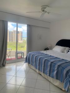 a bedroom with a bed and a large window at Seabreeze suite in Cupe Coy