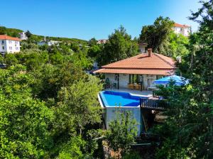 a house with a swimming pool in the trees at Villa Defne Kaş in Cukurbag