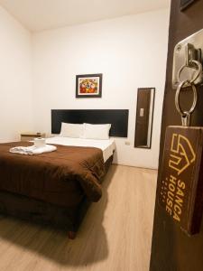 a hotel room with a bed and a chain at SANCA HOUSE Hostel in Trujillo