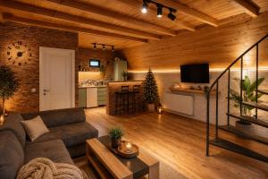 a living room with a couch and a kitchen at Memoria Kazbegi in Arsha