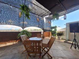 a patio with a table and chairs and a television at Hotel Asturias in Girardot