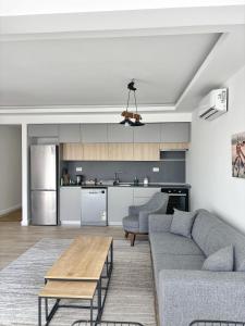 a living room with a couch and a table at Modern Garden House in Tivat