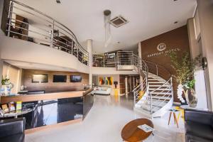 a living room with a spiral staircase in a building at Rapport Hotel in Juazeiro