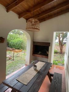 a dining room with a table and a fireplace at Casita colonial en Chapadmalal in Chapadmalal