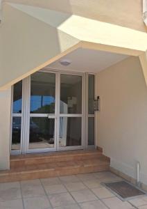 an outside view of a house with sliding glass doors at Le recantou duplex in Marseillan +9 photos