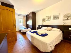 a hotel room with two beds with towels on them at El Naranjo del Abuelo in Málaga