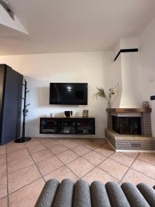 a living room with a flat screen tv on a wall at Casa Amor Iseo Lake in Riva di Solto