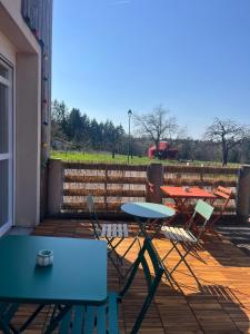 a group of tables and chairs on a patio at Le pré des noisettes in Angomont