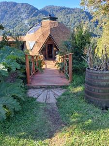 a home with a wooden walkway leading to a building at Alma Lemu Lodge in Los Ladrillos +21 photos